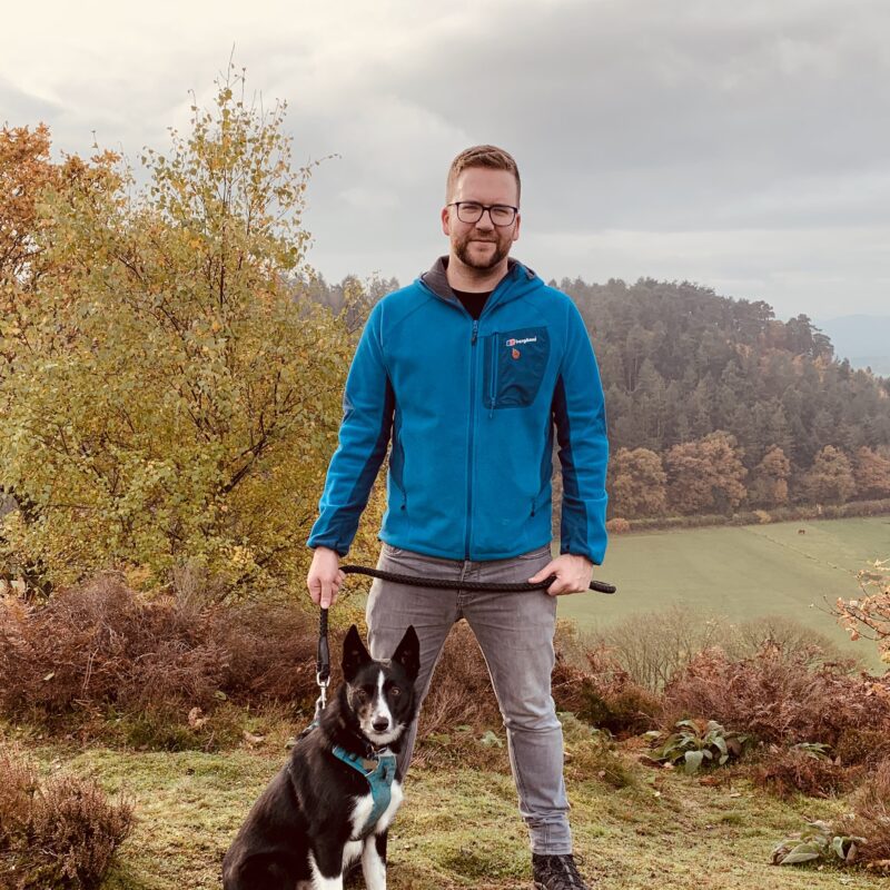 Sam Edwards, founder of Don't Hide, outdoors in the Autumn with his dog