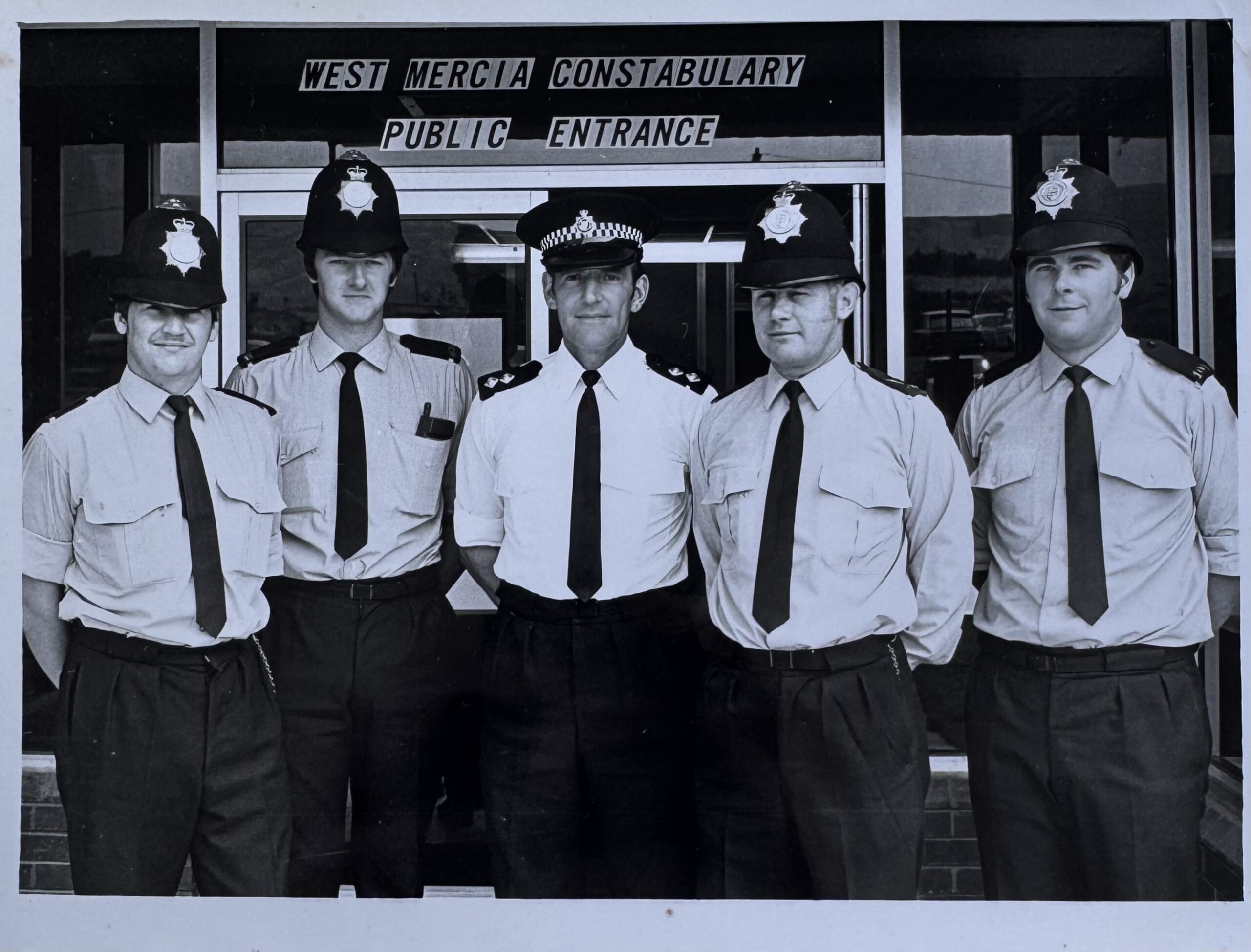 5 men wearing police uniforms